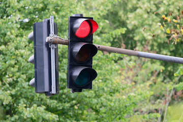 Red traffic light glowing on overhead metal structure