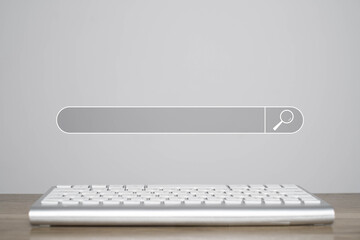 A minimalist image featuring a keyboard in front of a search bar, symbolizing online searching and digital interaction.