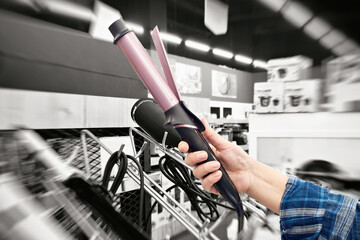 Curling hair iron in hand