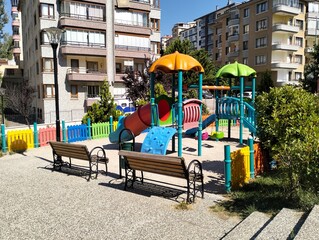Colorful children playground in the city park on a sunny summer day
