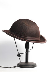 Scout hat hanging on a mini tripod isolated on a white background