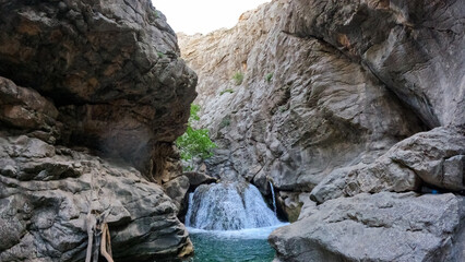 a river in a stone canyon. a river in the mountains