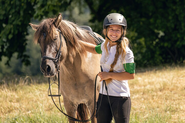 A young woman happily interacts with her horse after winning a riding competition