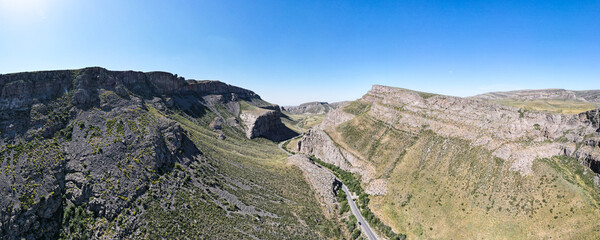 a road through a stone canyon