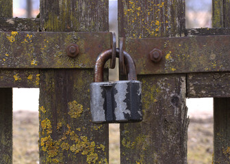 Old gate with a worn lock