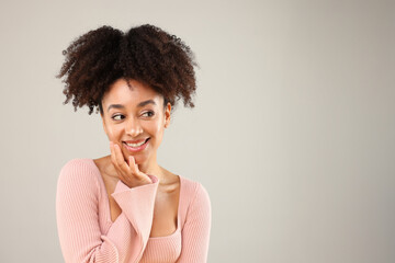 Portrait of beautiful Brazilian woman on gray background, space for text