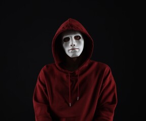 Anonymity. Man wearing mask on dark background