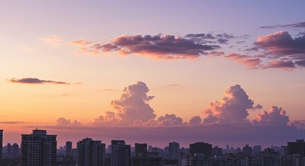 Fototapeta premium Majestic Cumulus Clouds Illuminated by Golden Hour Sunset Over City Skyline