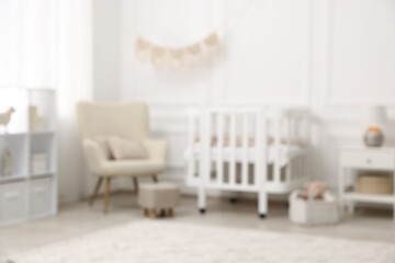 Baby room interior with crib and other furniture, blurred view