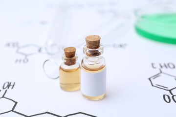 Bottles of cosmetic products, test tubes and Petri dish of sample on paper with chemical formulas,...