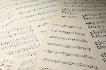 Sheets with musical notes as background, closeup