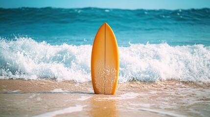 A yellow surfboard standing on a sandy beach with waves in the background.