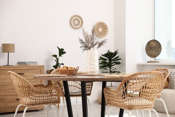 Stylish table with chairs and decor in dining room. Interior design