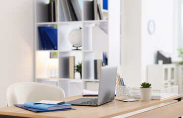 Doctor's workplace with modern laptop on desk in office