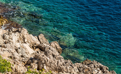 Clear aquamarine waters of the Mediterranean Sea at Cala Fredda Beach on Levanzo Island, Sicily.