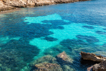 Clear aquamarine waters of the Mediterranean Sea at Cala Fredda Beach on Levanzo Island, Sicily.