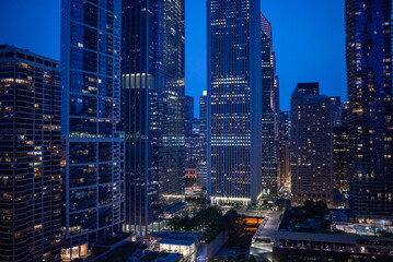 Nighttime urban skyline view showcasing modern skyscrapers illuminated by city lights in a bustling...