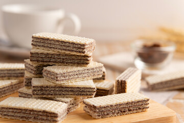 Pile of Wafer filled with cocoa cream flavored on wooden plate