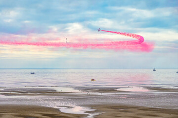 Blackpool, England - 10th August 2025: The Red Arrows performing an aerial display using red, white and blue smoke over the North Pier as part of the Blackpool Air Show