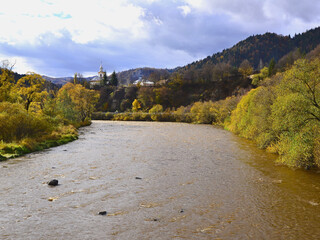 Hills with autumn colours and Orthodox church in the background