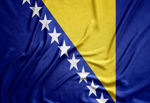 blue with stars flag of the European republic of Bosnia and Herzegovina on a rough canvas with folds and shadows
