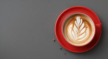 Overhead view of a red cup of latte art on a gray background, with coffee beans scattered nearby