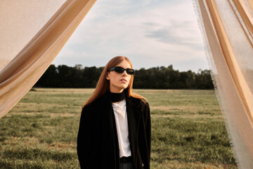 Stylish young man with long red hair embraces autumn fashion during golden hour outdoors