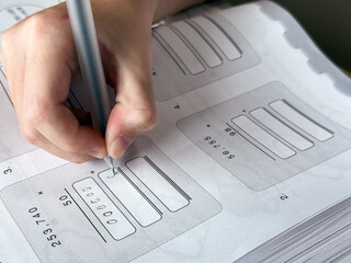 A young student sits at a wooden desk working on basic math exercises, steadily developing essential problem solving skills.