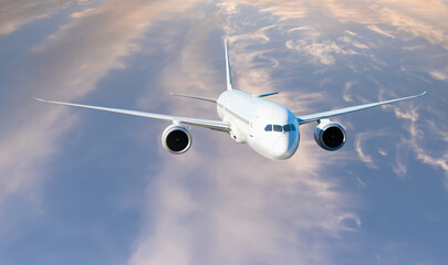 White passenger airplane flying in the sky amazing clouds in the background - Travel by air transport