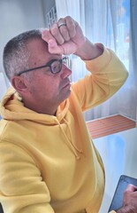 A man sitting at his desk looks at his computer, worried and stressed. Problems at work. Unpaid...