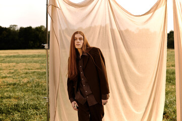Stylish redhead young man embraces autumn fashion in golden hour outdoors