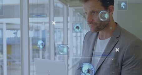 Professional in blazer holding laptop typing in glass-walled hallway with overlay icons, copy space