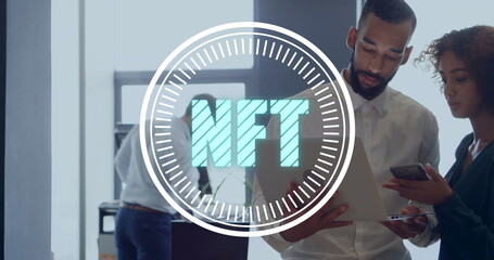 Collaborating coworkers focusing on laptop and smartphone at open office, with NFT overlay