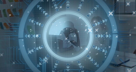 Analyzing colleagues in business attire consulting laptop and tablet at office table, with overlay