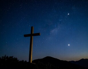 Cross atop a hill under a starry night sky
