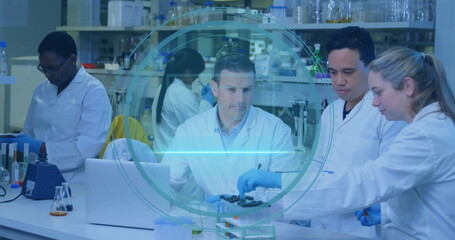 Conducting experiments five scientists in lab coats and gloves at lab bench, with test tubes