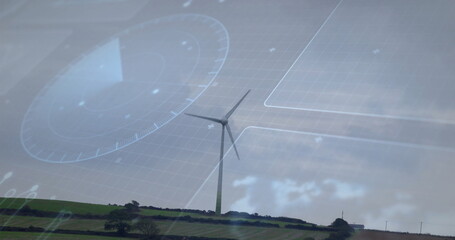Solitary wind turbine rotating blades on grassy hill, with hedgerows, trees, digital HUD overlays