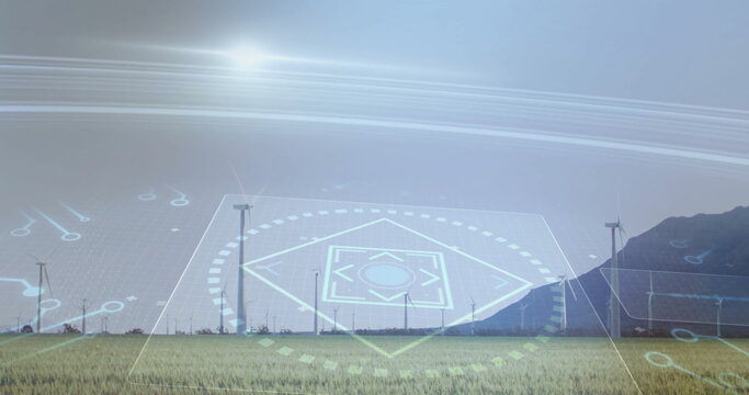 Featuring row of wind turbines with transparent digital HUD overlay in grassy field, mountain ridge