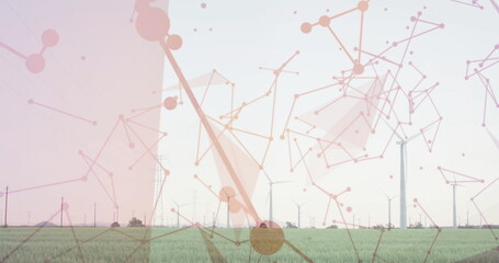 Wind turbines, power lines and transmission towers standing in rural field, with network overlay