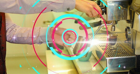 Frothing barista hands creating microfoam at coffee counter, with milk pitcher and red tie detail