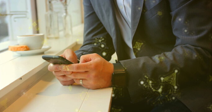 Businessman in dark blazer holding smartphone at café bar with coffee cup pastry smartwatch ring - Powered by Adobe