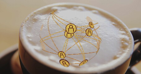 Dark coffee mug displaying frothy milk foam on counter projecting golden digital network sphere