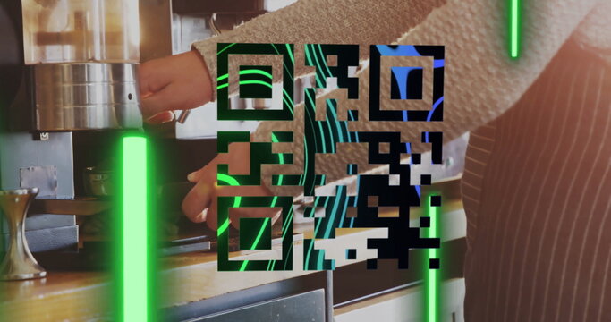 Barista in apron securing portafilter under espresso maker at coffee counter with neon QR code bars