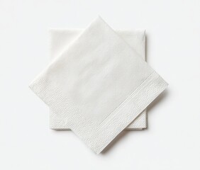 Fototapeta premium Two pristine white paper napkins, slightly overlapping, lie on a stark white background, exhibiting a subtle texture and folded edges