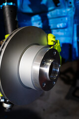 New brake rotor and caliper installation on custom suspension. High-performance brake and coilover...
