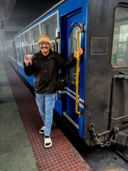 Tourist posing outside Toy train int Darjeeling WB