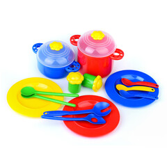 A set of toy colored plastic tableware on a white background.