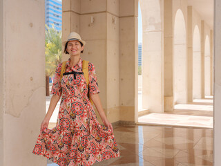 Young woman exploring Qasr Al Hosn Park in Abu Dhabi. Surrounded by lush greenery and historical...