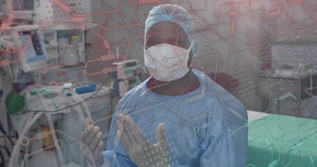 Circuit overlay fading in, surgeon making prayer gesture in operating room, preparing for surgery - Powered by Adobe