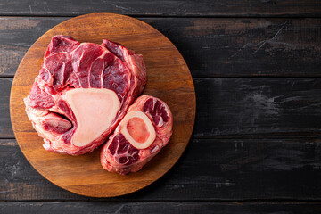  Raw osso buco beef on the cutting board and black wooden background, top view copy space for text